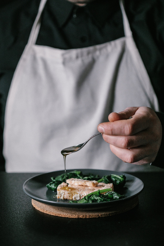 Moody Restaurant Dining and Service Chef Plating a Dish